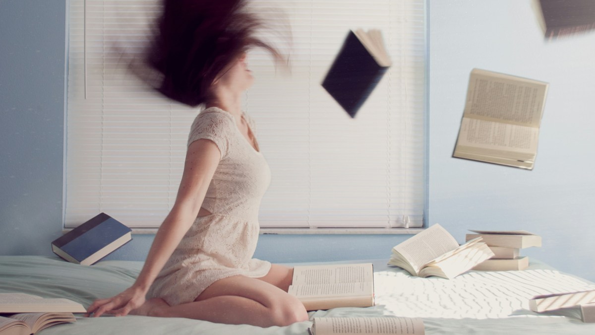 
a-woman-surrounded-by-flying-books
