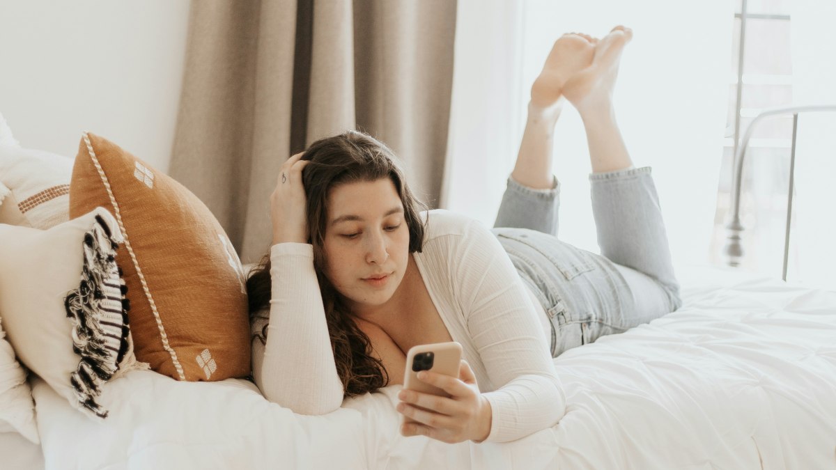 
a-woman-using-an-online-dating-app-in-bed
