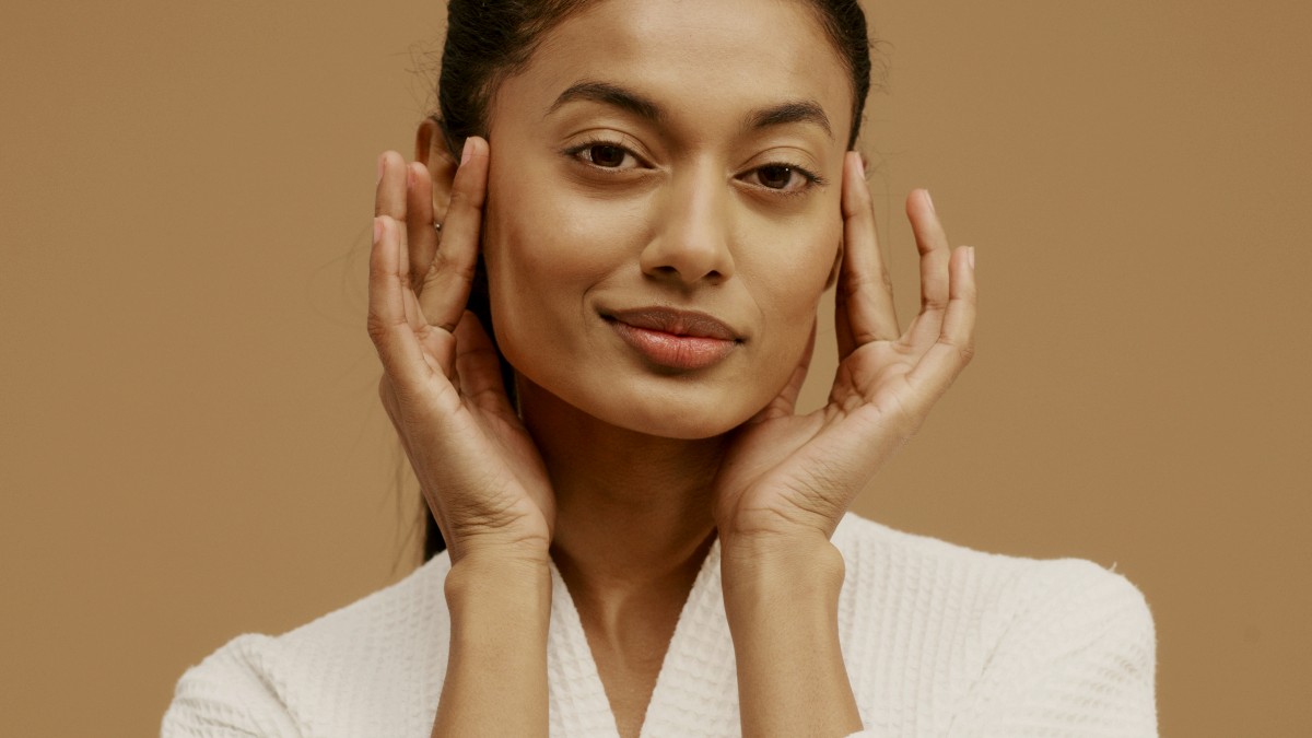 
a woman with her hands on the side of her face
