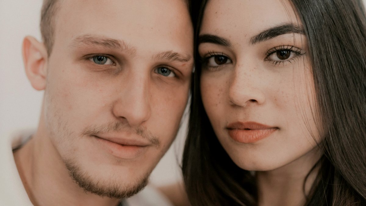 
A young man and a woman posing for a picture together
