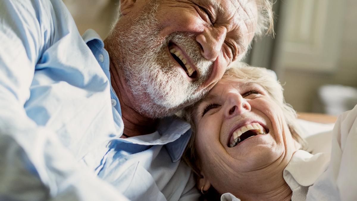 
An elderly couple is spending time together laughing holding hands by curated lifestyle
