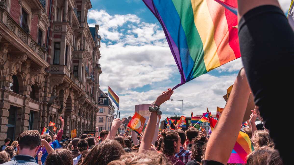 
an lgbt march with a rainbow flag
