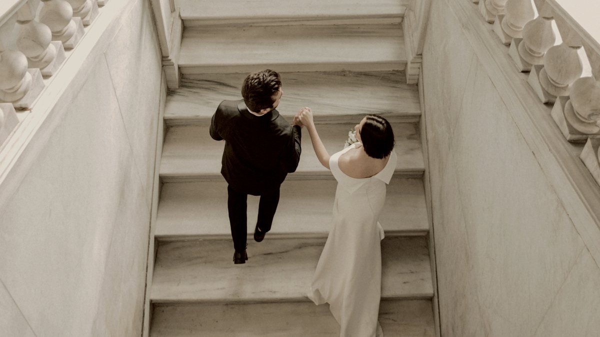 arial view of a bride and groom walking up a flight of stairs by Mesut çiçen