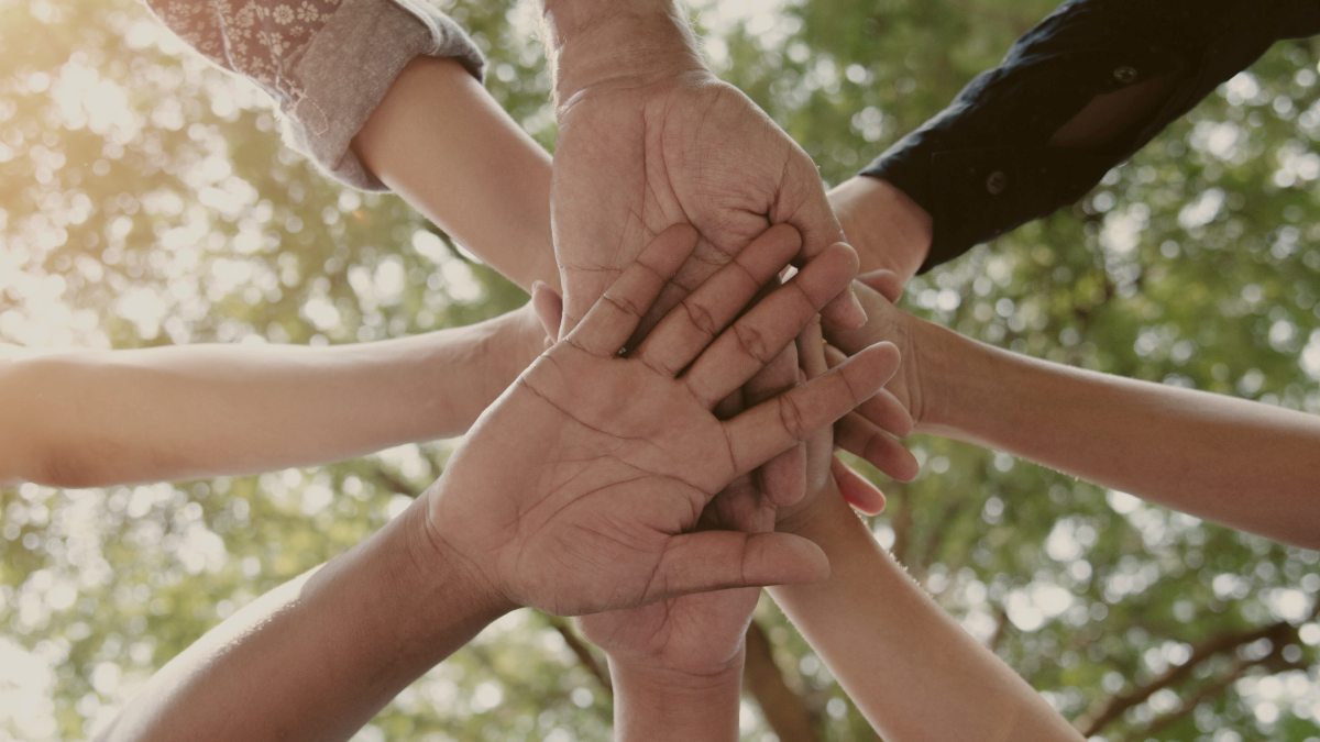 
diverse peoples hands joined captured from below by Getty Images
