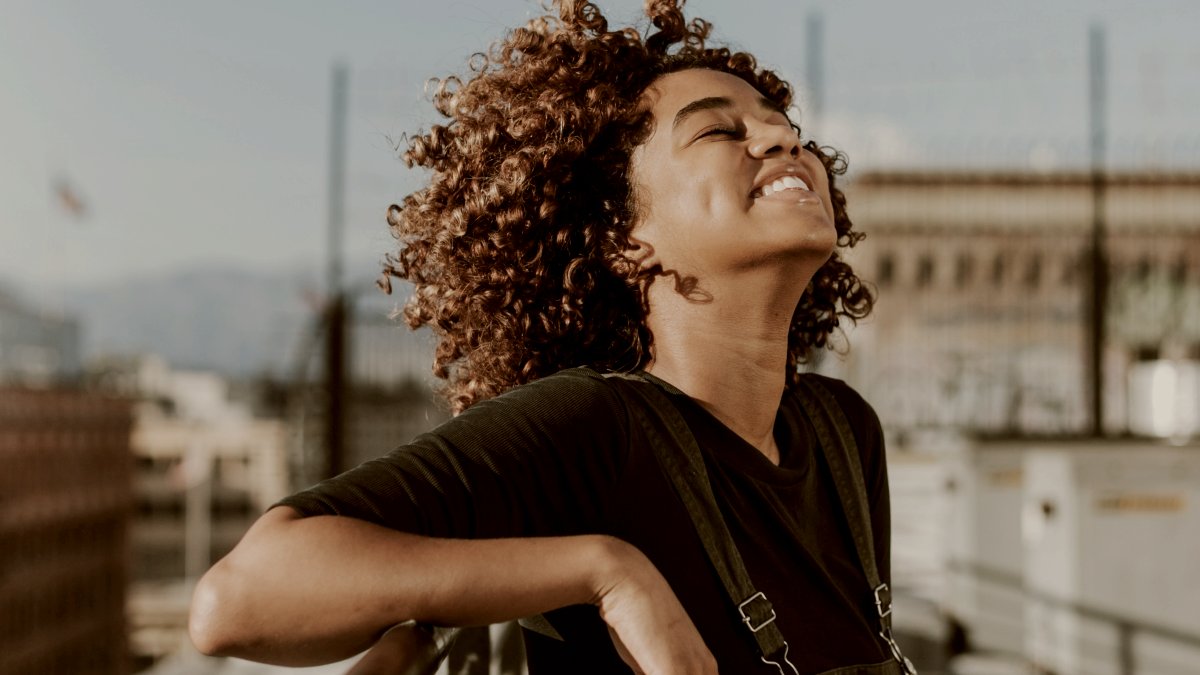 
Girl with curly hair at a LA rooftop smiling by Curated Lifestyle
