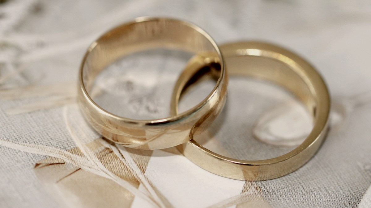 
gold wedding band on white textile by Sandy Millar
