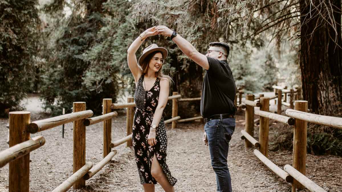 
man and woman dancing between brown wooden handrails
