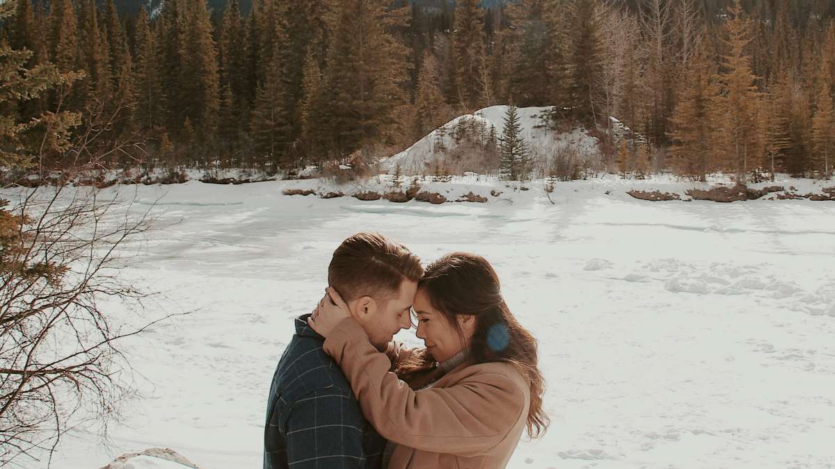 
man-and-woman-embracing-on-a-snowy-mountainside
