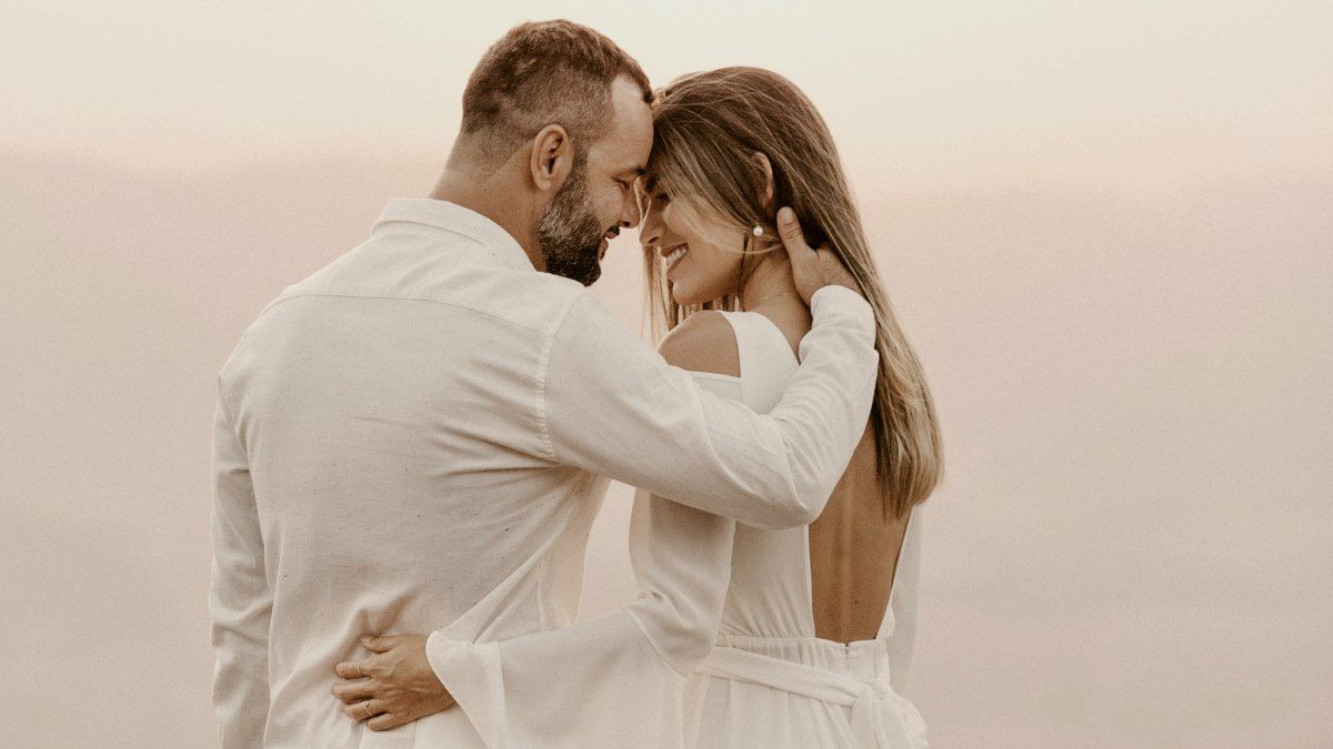 
man and woman hugging each other in an engagement photoshoot
