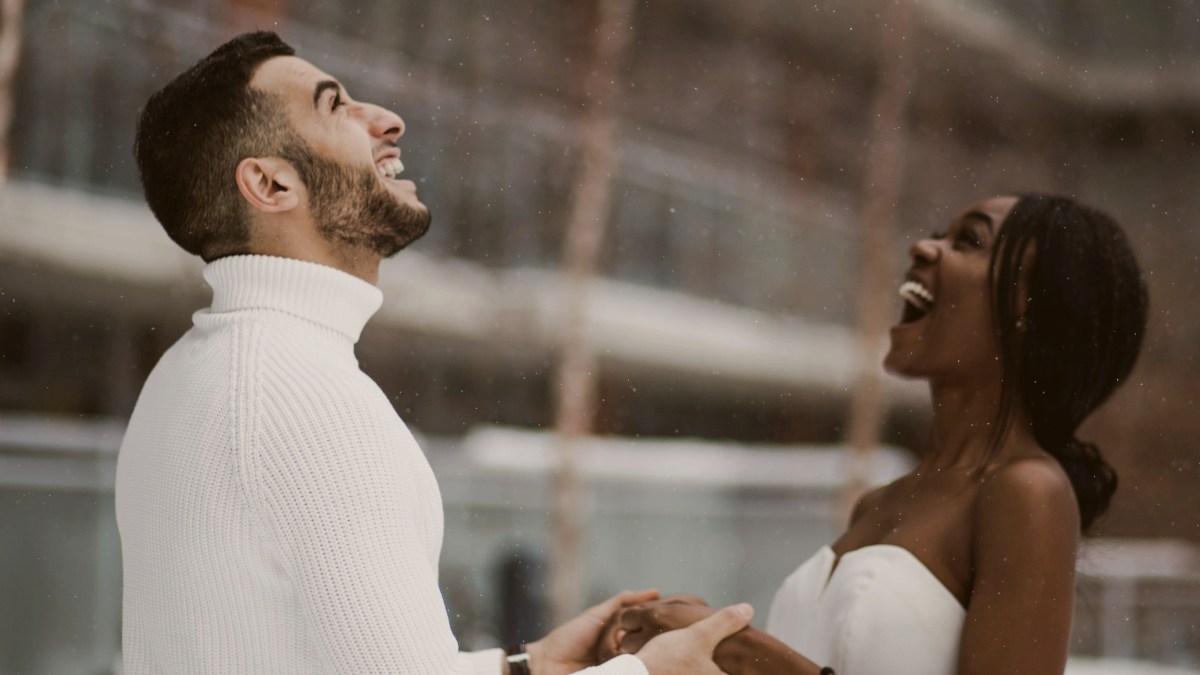 
man and woman smiling upon seeing the first snow
