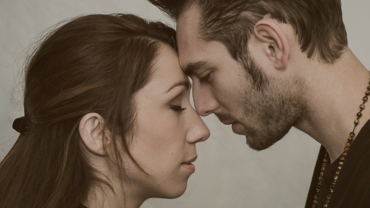
man and woman with foreheads pressed against each other by JEREMY MALECKI
