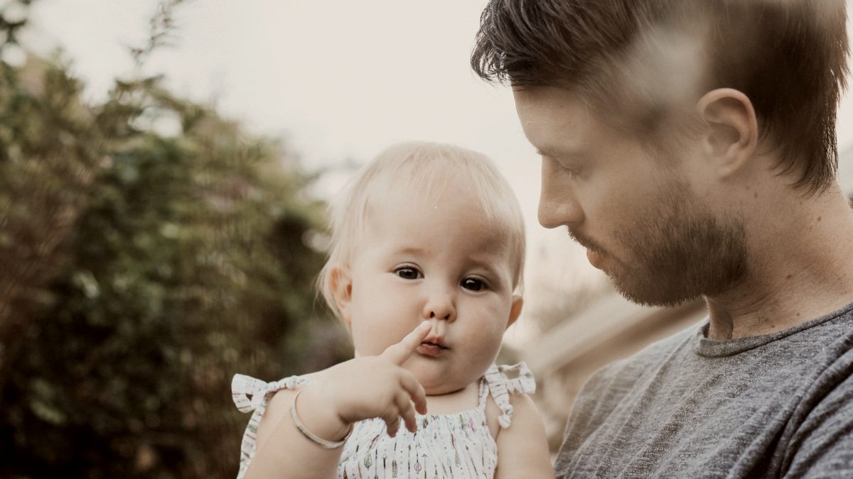 
man holding baby in white shirt
