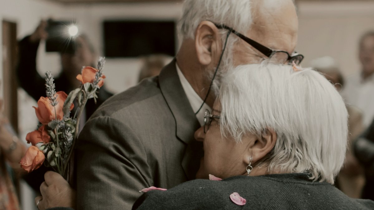 
man in black suit jacket kissing woman in white hair by gaspar zaldo
