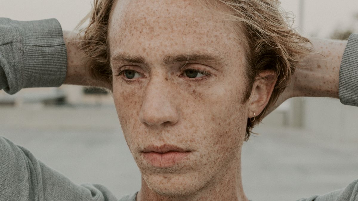 
man in grey crew neck shirt with freckles by Nathan Dumlao
