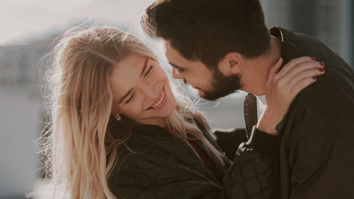 
man-trying-to-kiss-a-woman-while-she-turns-her-face-away
