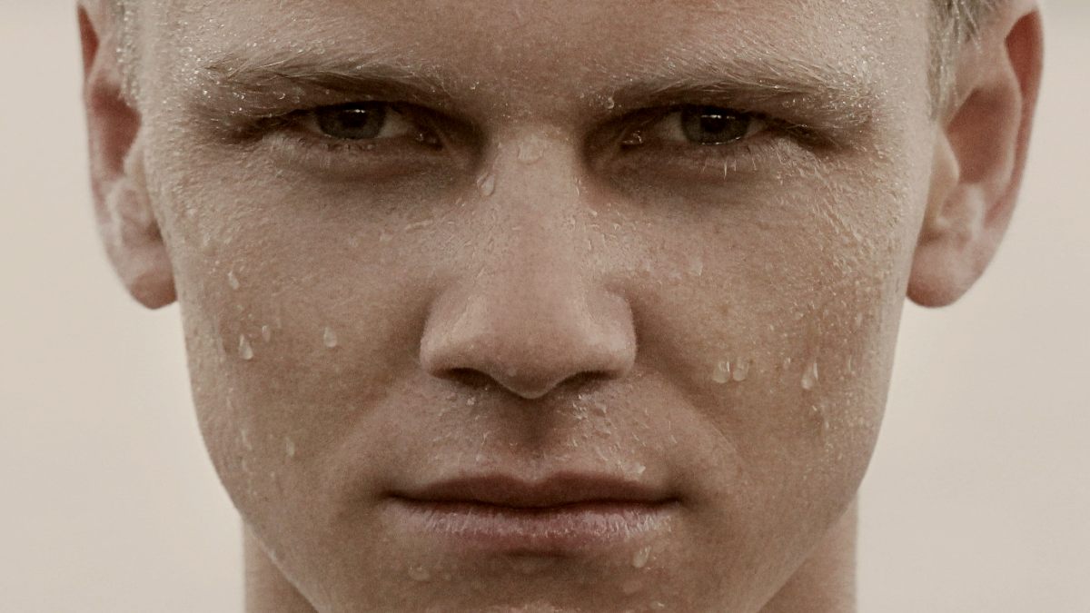 
man with water droplets on his face
