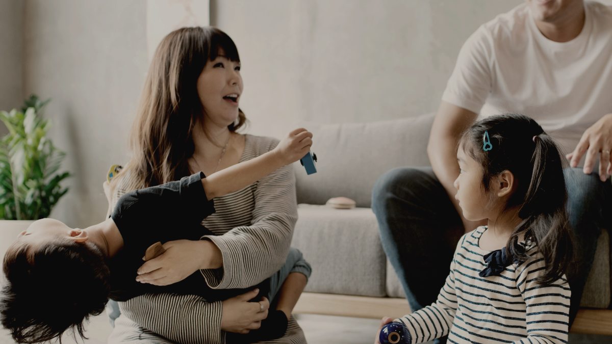 
mom and dad playing with their two young children by Curated Lifestyle
