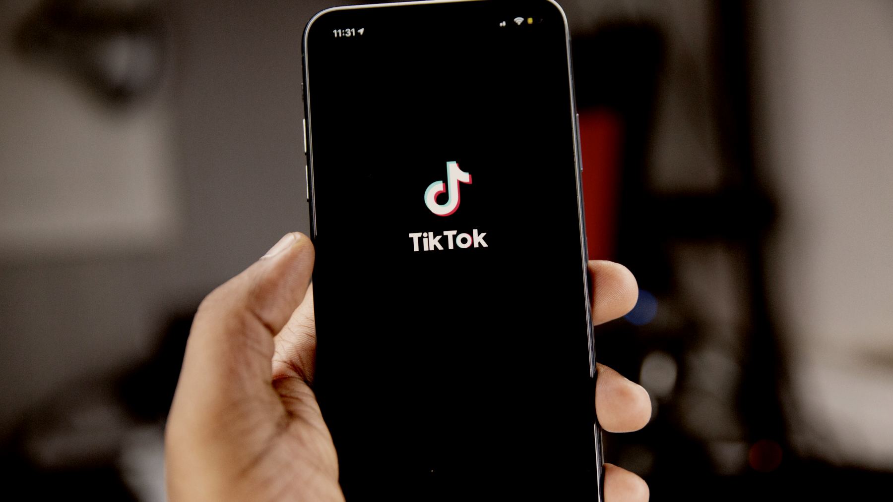 
person holding black iphone 5 with tiktok app open by Solen Feyissa
