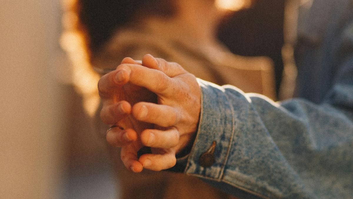 
person in blue denim jacket touching hands with person in tan jacket by Natalia Sobolivska
