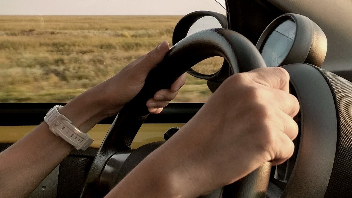 
person with white watch driving car by alex chernenko
