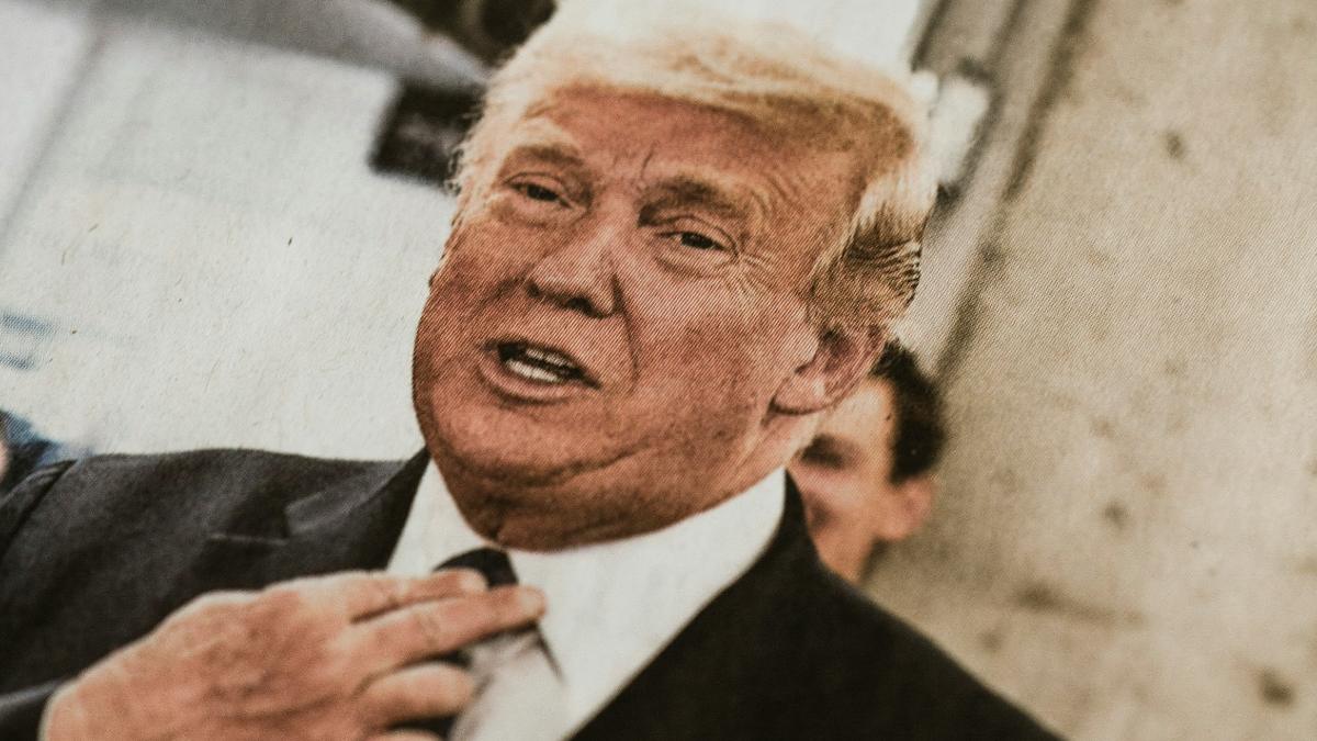 
photo of newspaper clipping of president trump in black suit jacket by markus spiske
