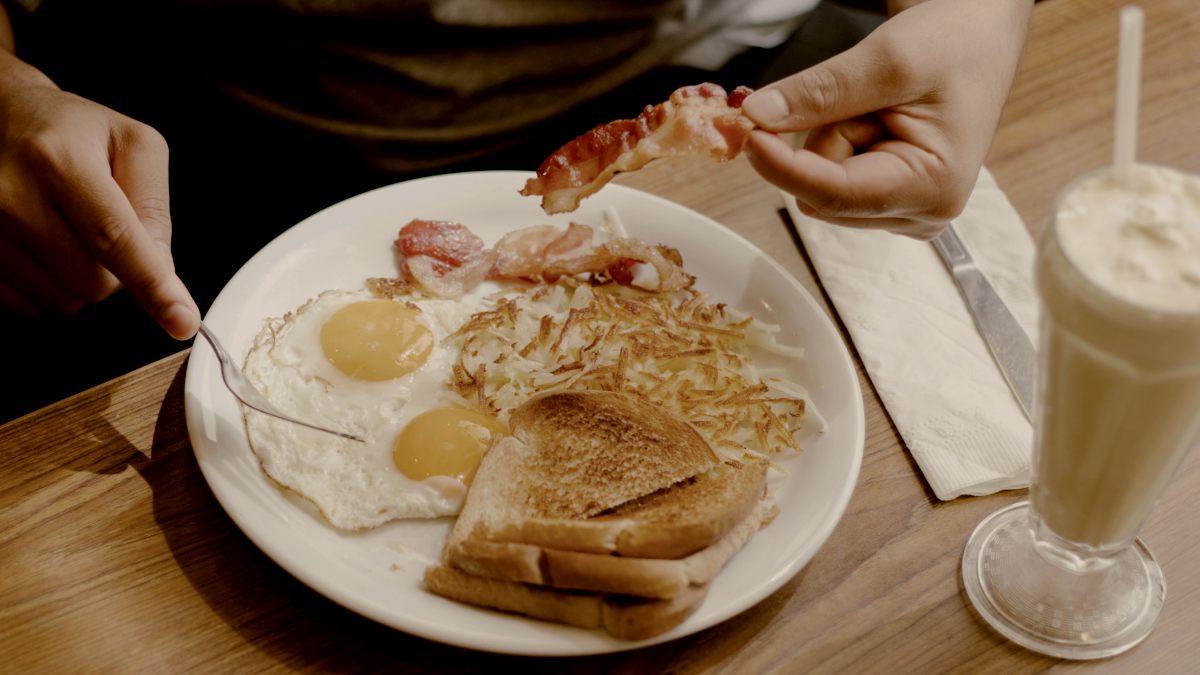
Someone is enjoying a delicious breakfast of eggs toast and bacon with a milkshake on the side by Ramsés Cervantes
