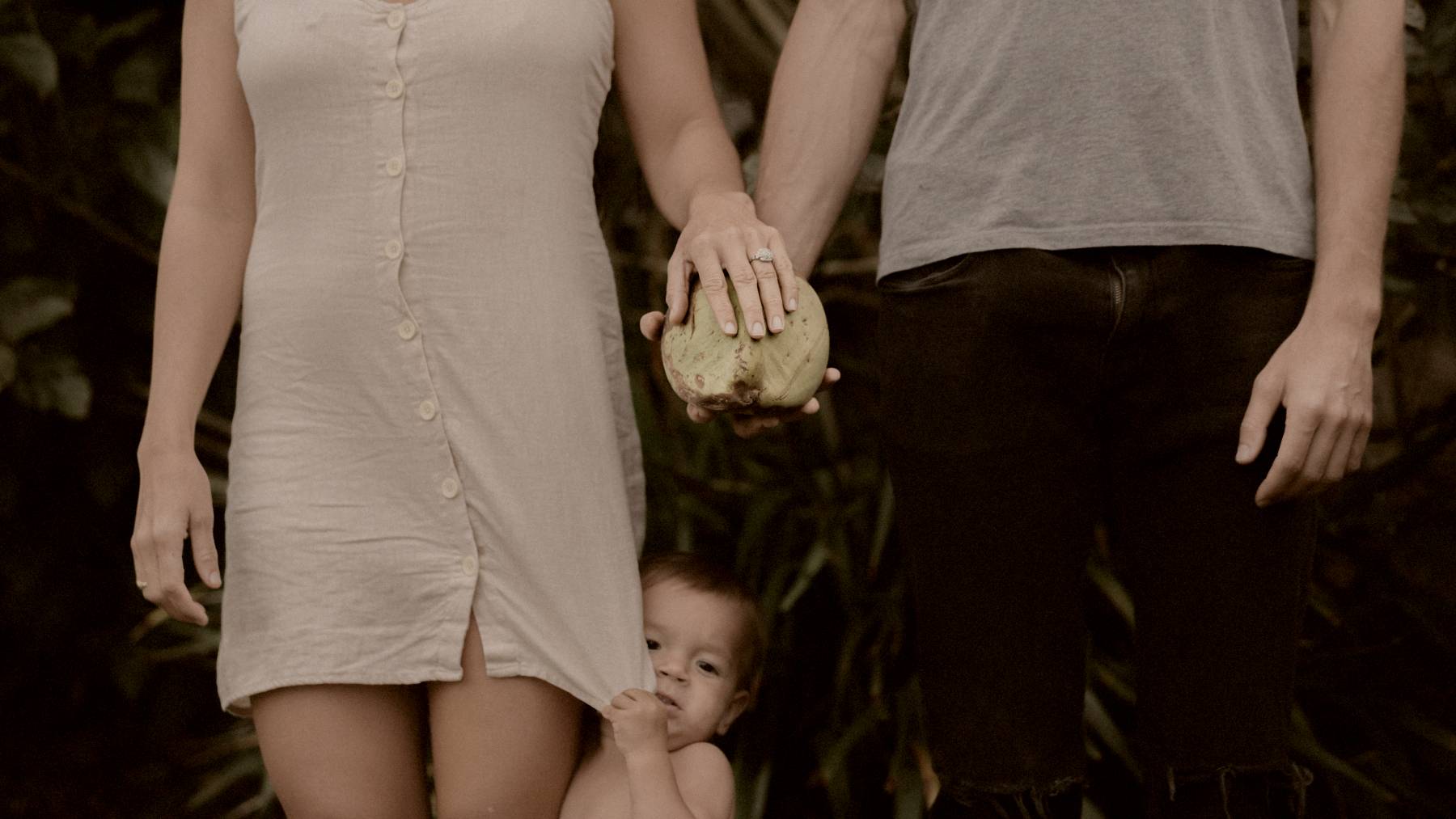 
toddler between woman and man standing by Jakob Owens
