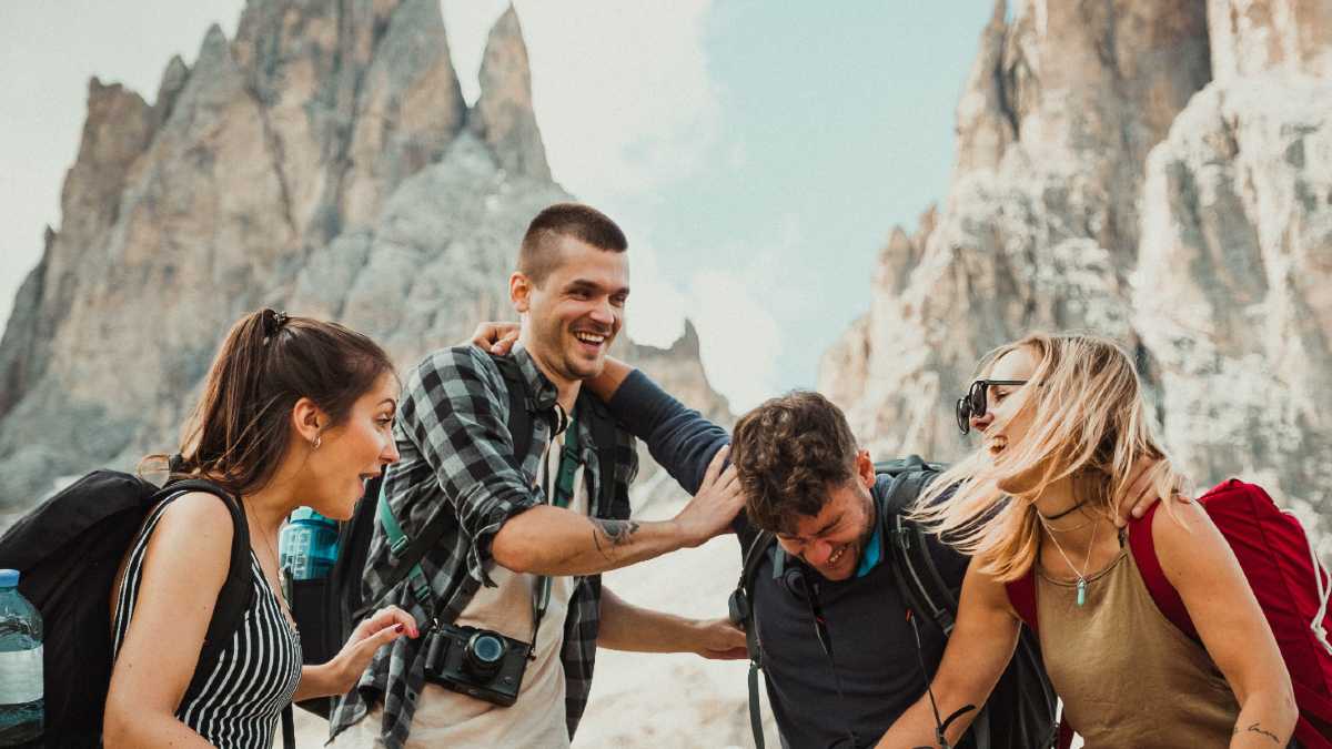 
Two couples on a hike who care about the environment and are happy.
