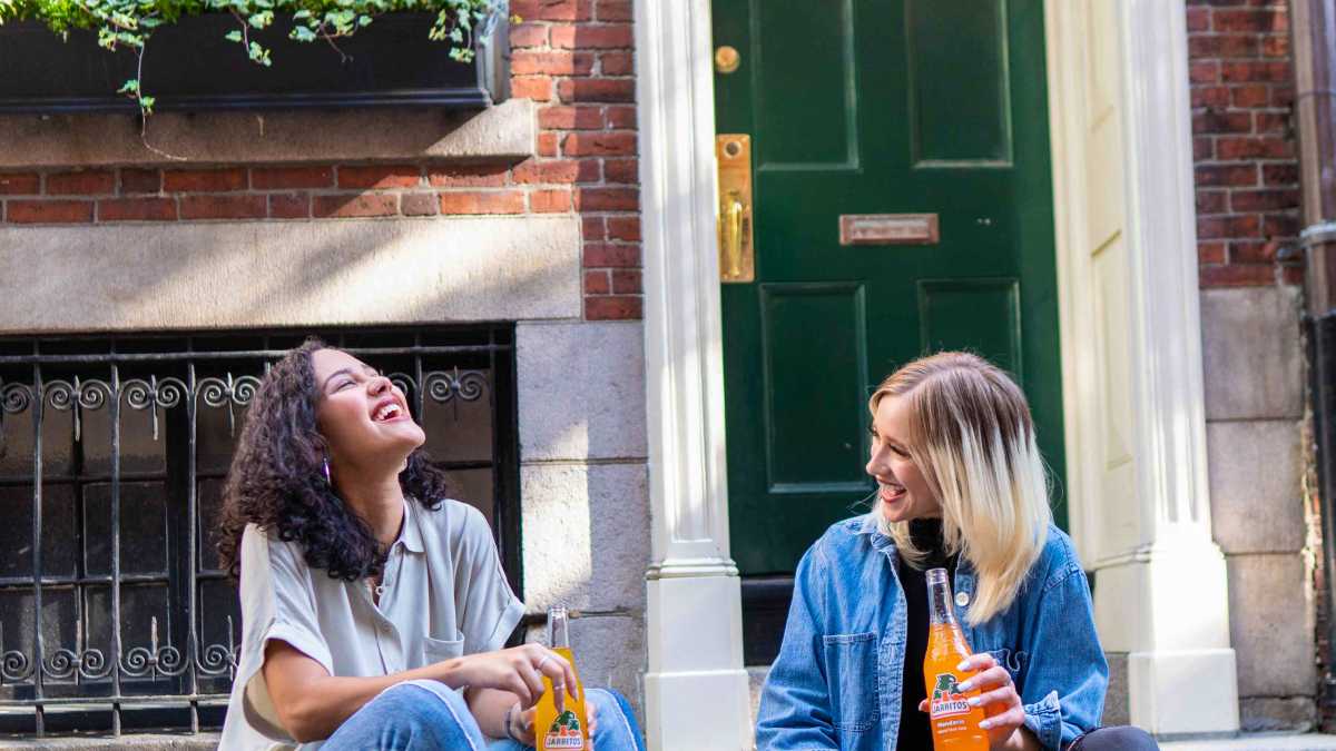 
two friends laughing and enjoying each others company because they have worked out their differences
