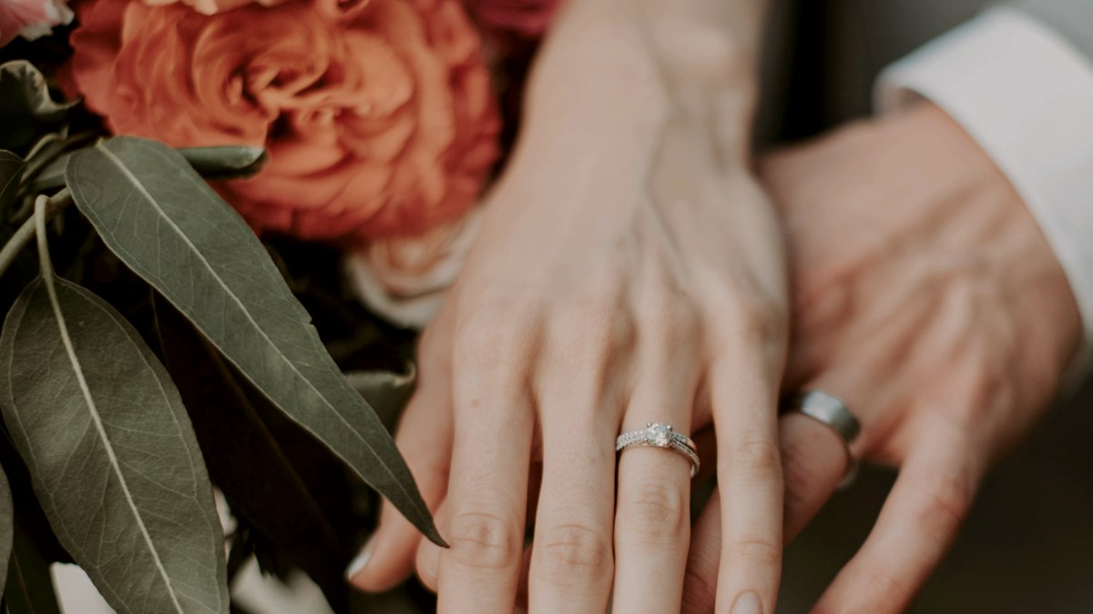 
two-hands-with-silver-wedding-bands
