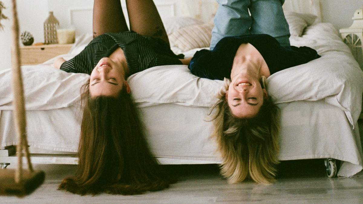 
two-sisters-hanging-around-on-a-bed

