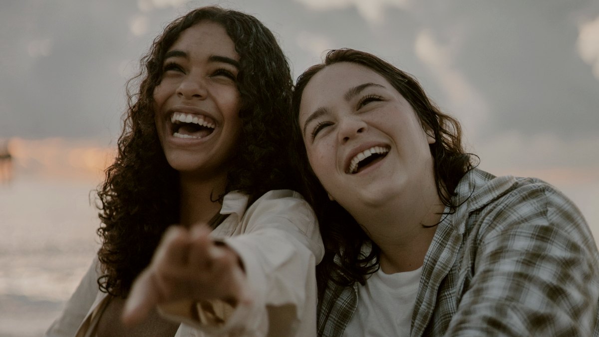 
two-women-laughing-together-and-leaning-on-one-another
