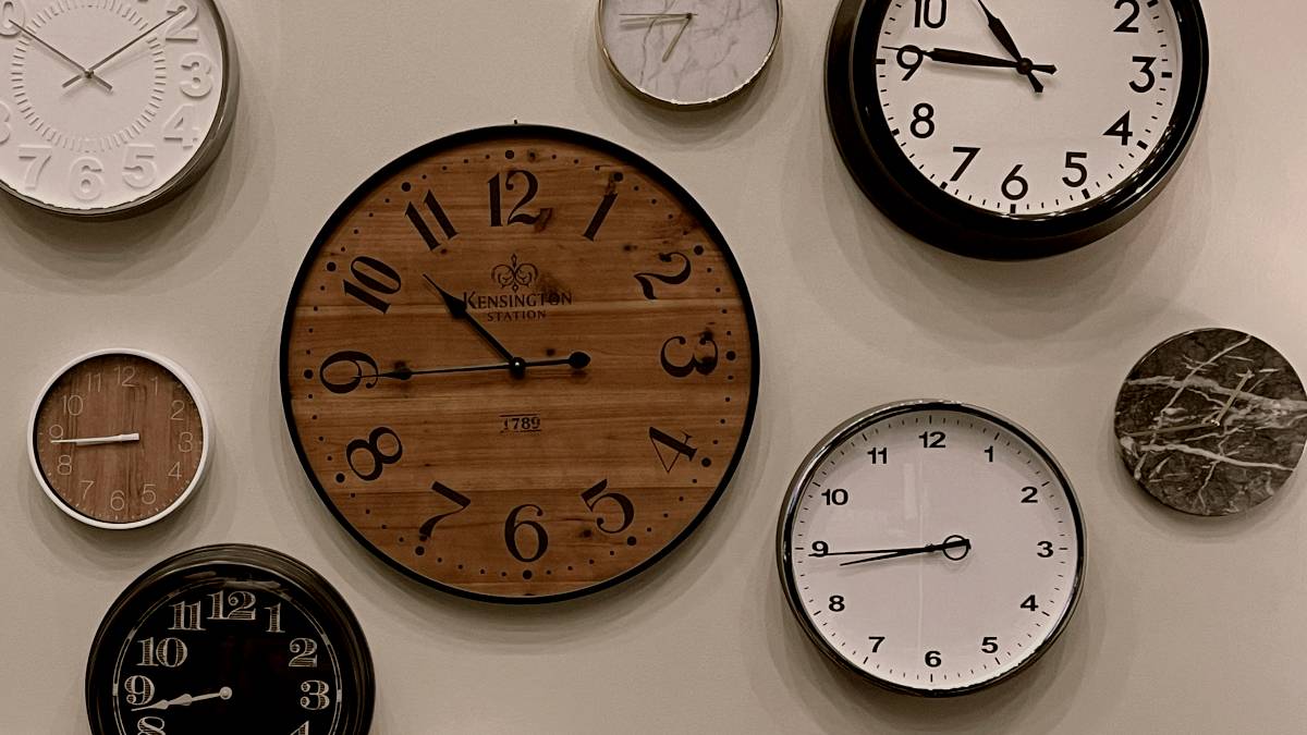 
white and brown analog wall clock at 10 00
