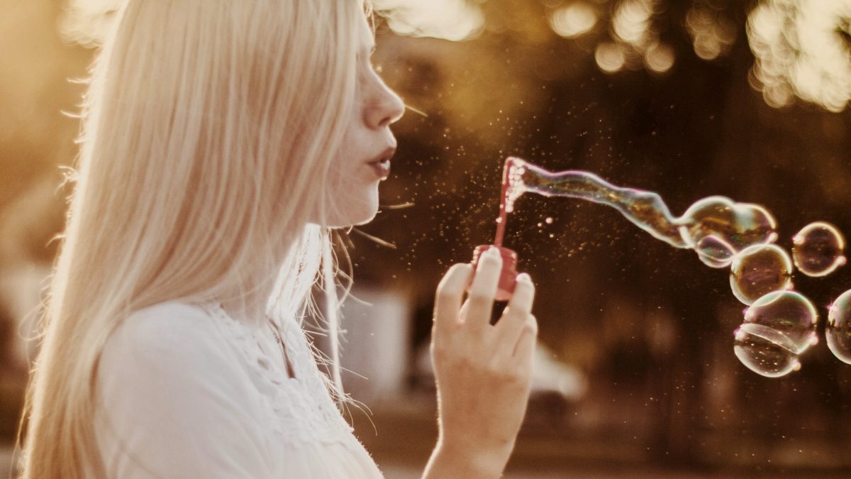 
woman blowing bubbles during sunset
