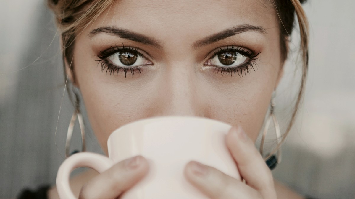 
woman-drinking-from-white-coffee-cup
