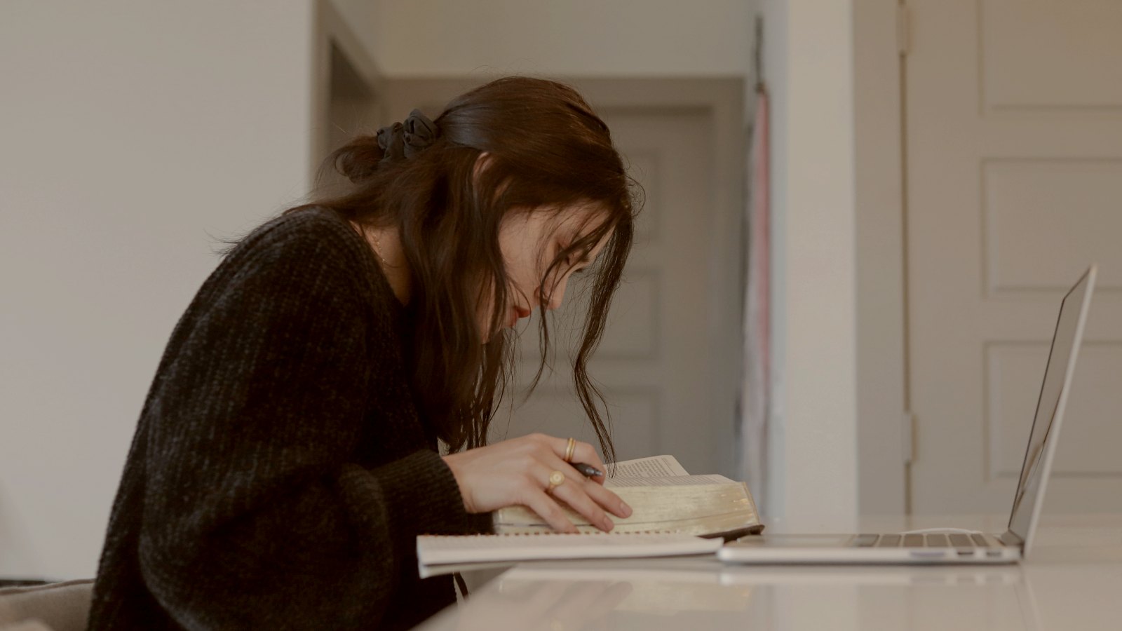 
woman in black long sleeve shirt reading book by Eliott Reyna
